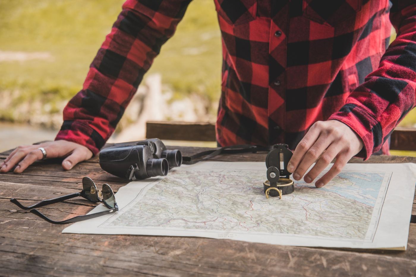 Surveyor checking a plan with a compass